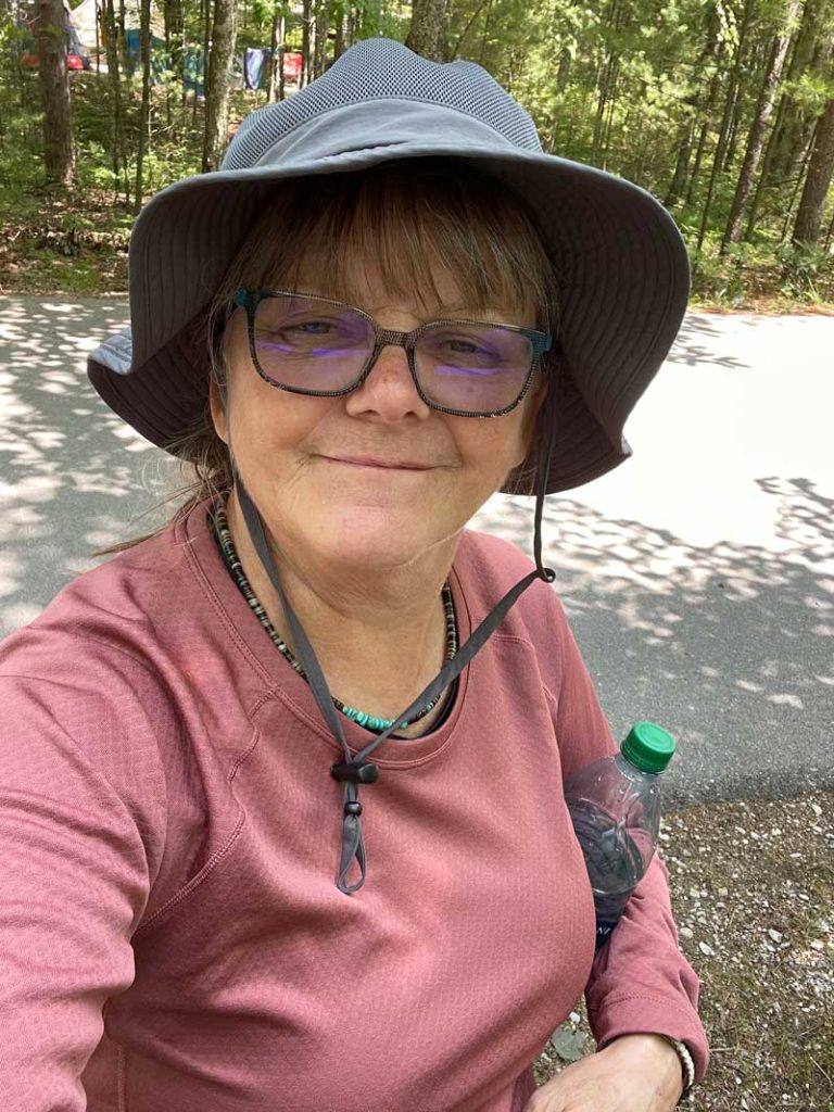 Ann smiling while camping